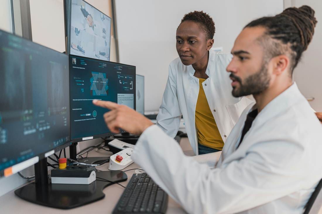 Two specialists reviewing evidence on screen